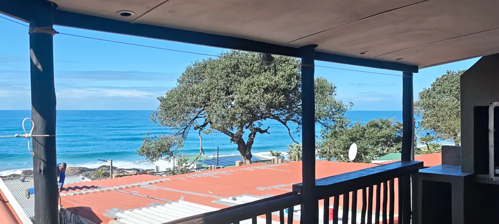 Sea view from the covered veranda at No 19, looking out over the rooftops to the beach