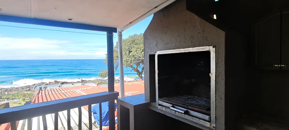 Built-in braai on the veranda, with the sea beyond