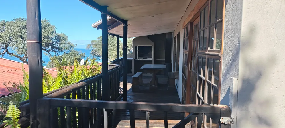 Covered veranda running along the front of the unit, with sea views