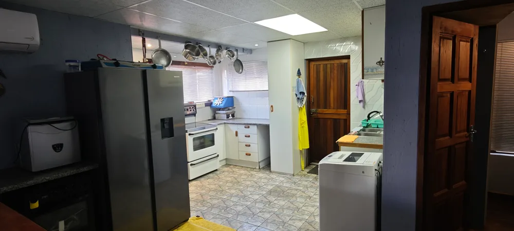 Kitchen with a fridge, stove and washing machine