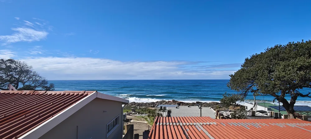 Wide view of the ocean and the beach below No 19
